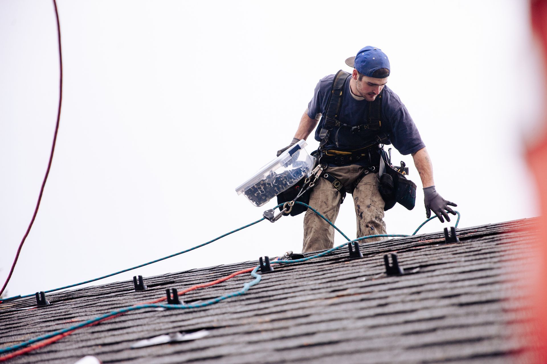 A man is working on the roof of a building.