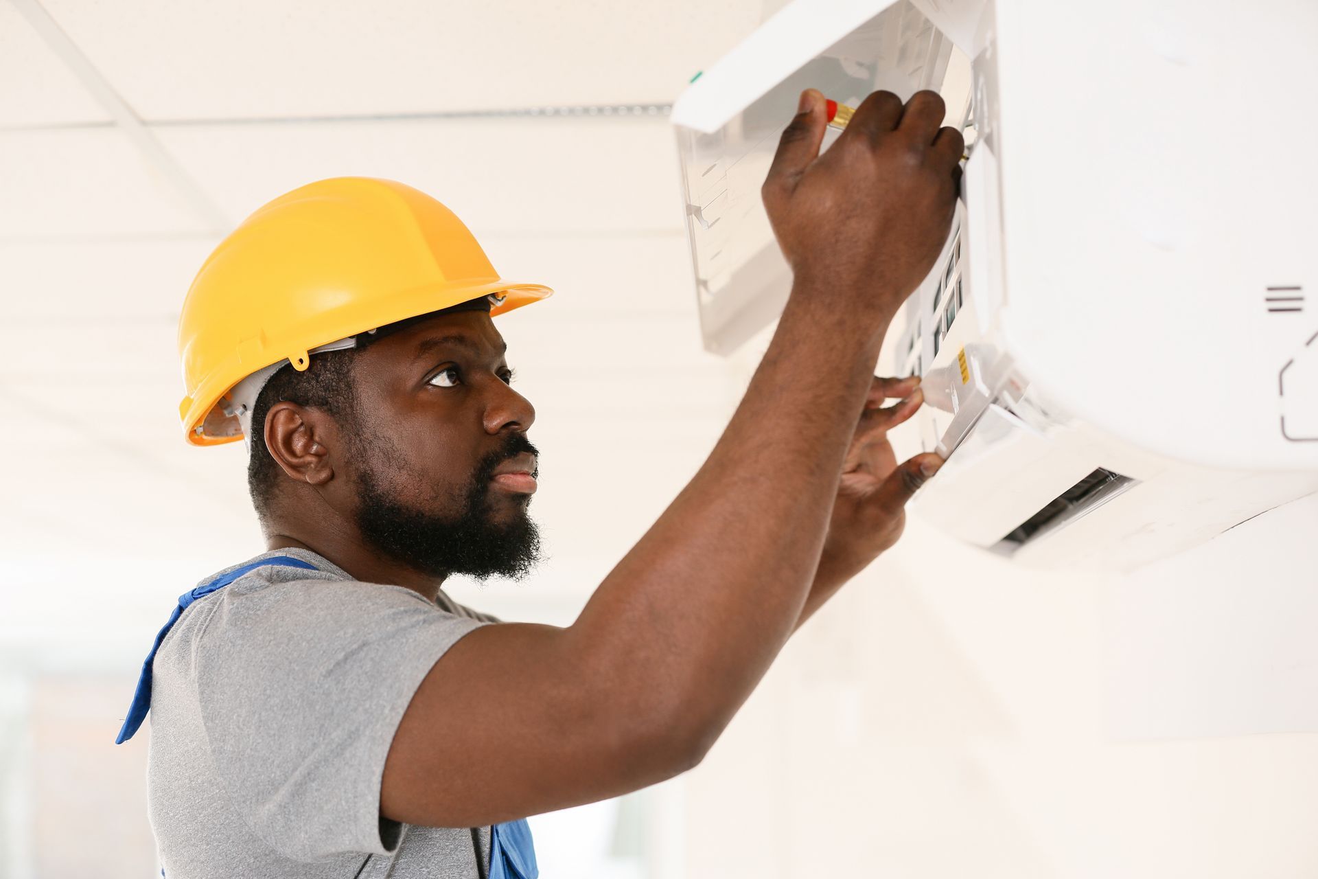 air conditioning repairman working on compressor