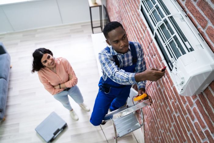 hvac technician working on air conditioner