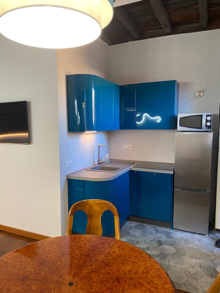Cucina ristrutturata a Roma Trastevere con nuovi elettrodomestici, arredi moderni e illuminazione a LED.