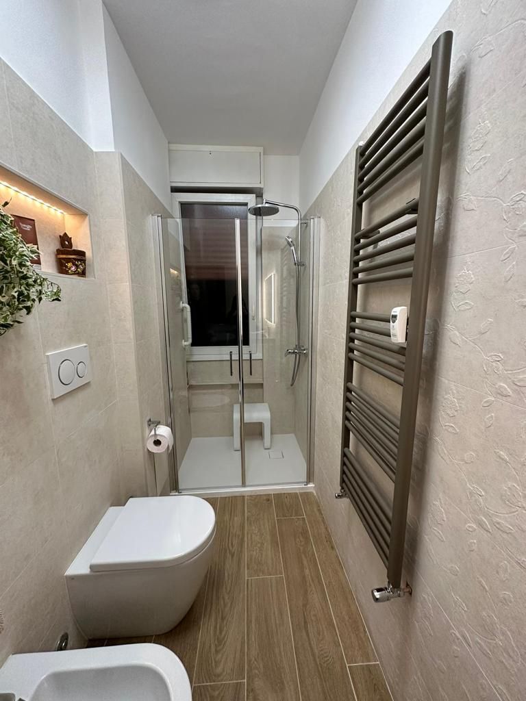 Lavabo minimalista con specchio moderno, parte della ristrutturazione del bagno a Roma EUR.