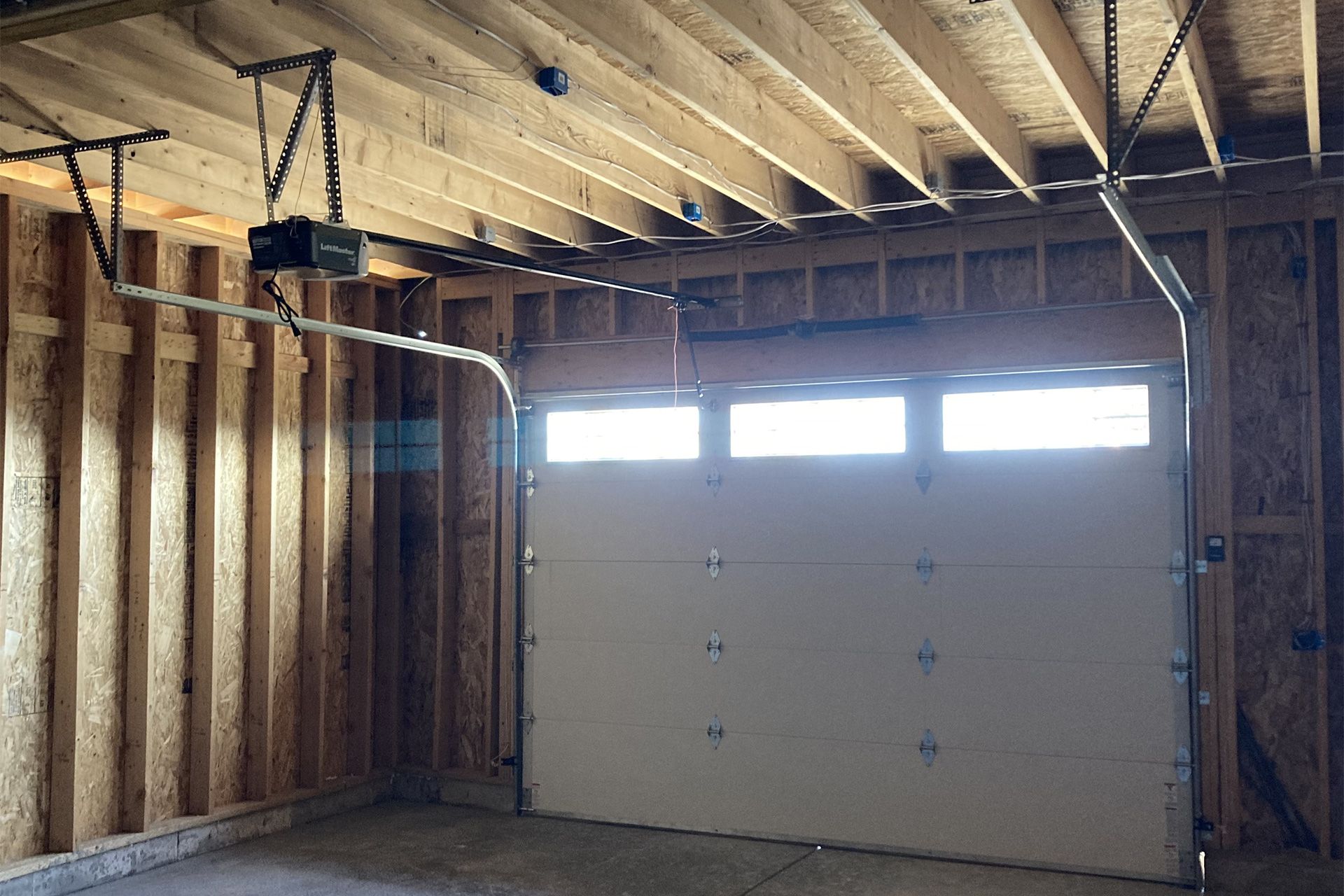 A garage door is open in a house under construction
