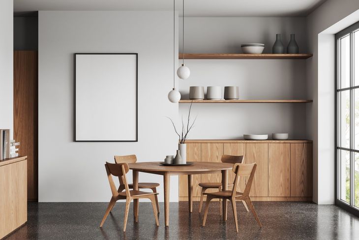 Modern dining area with wooden table and chairs, floating shelves, and a large window.
