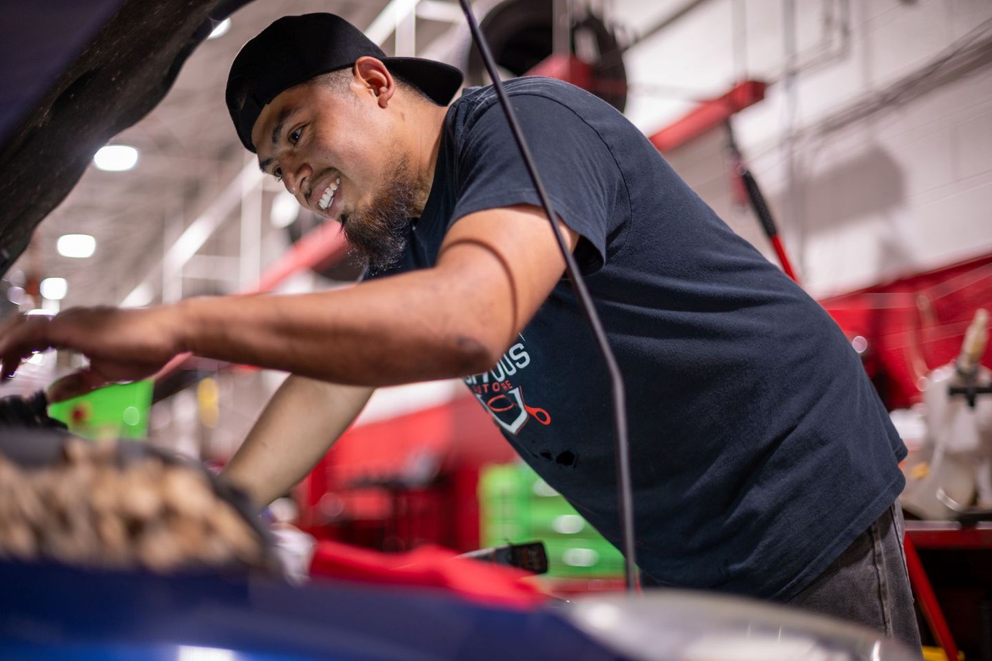 Mechanic in a garage, working on a car engine | Righteous Auto Care