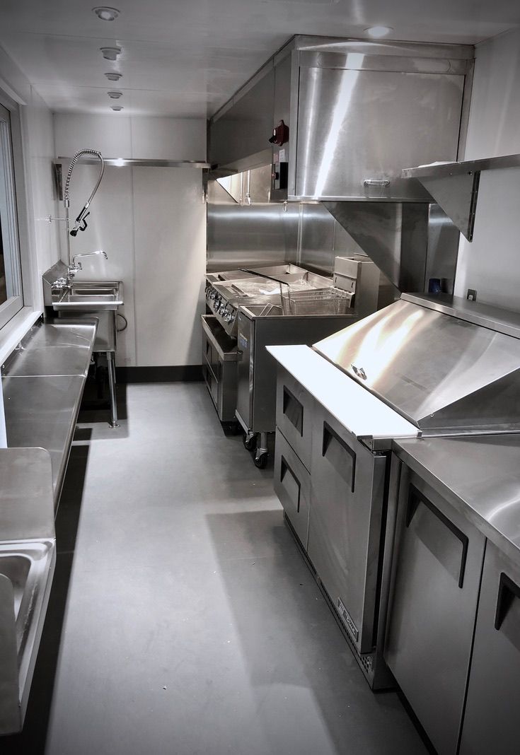 An expert stainless steel craftsman at Shanghai Mobile Kitchen Solutions cuts materials to spec.
