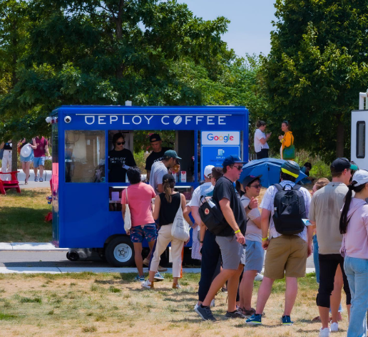 A group of people standing in front of a deploy coffee truck
