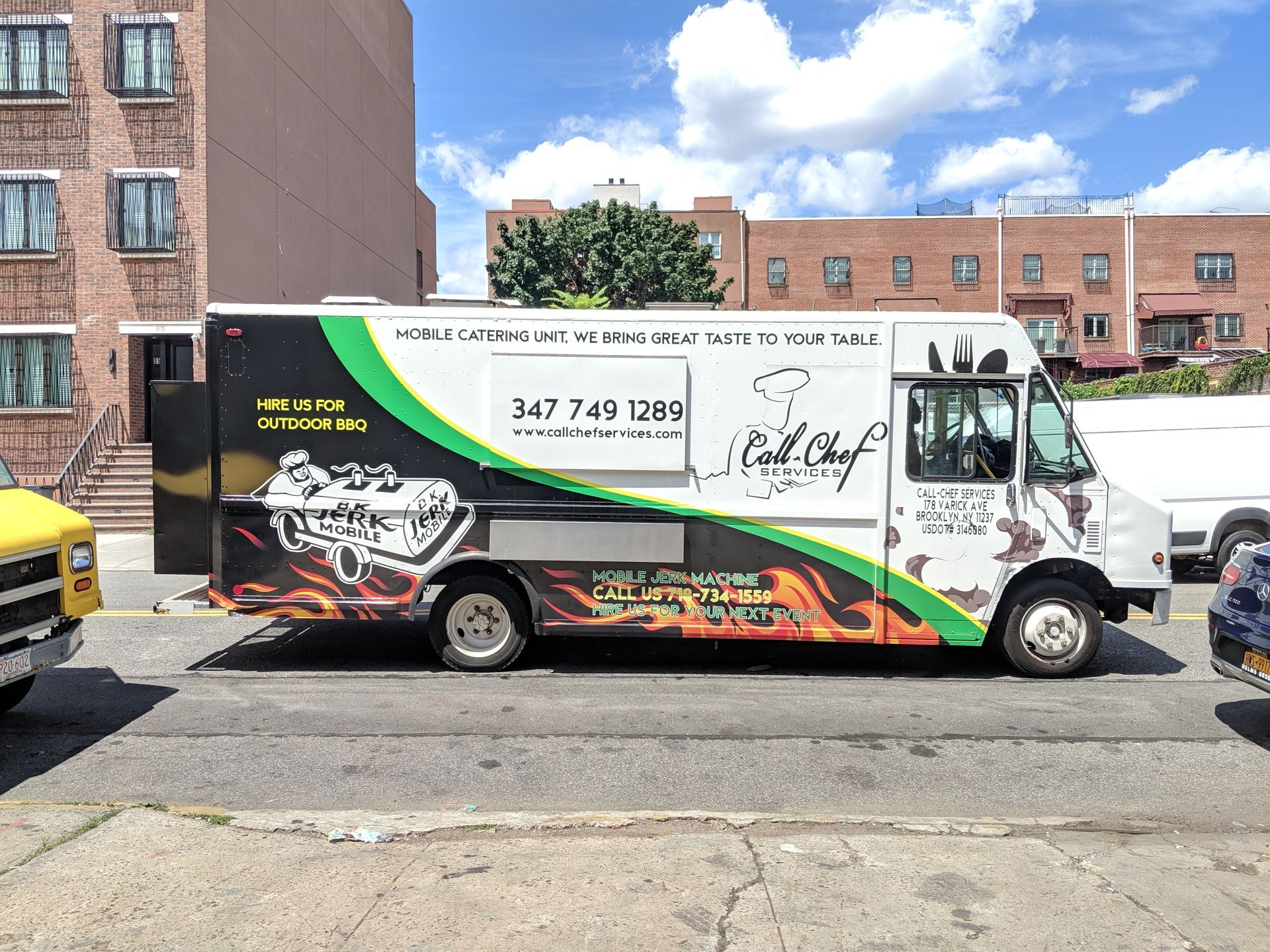 A food truck is parked on the side of the road.