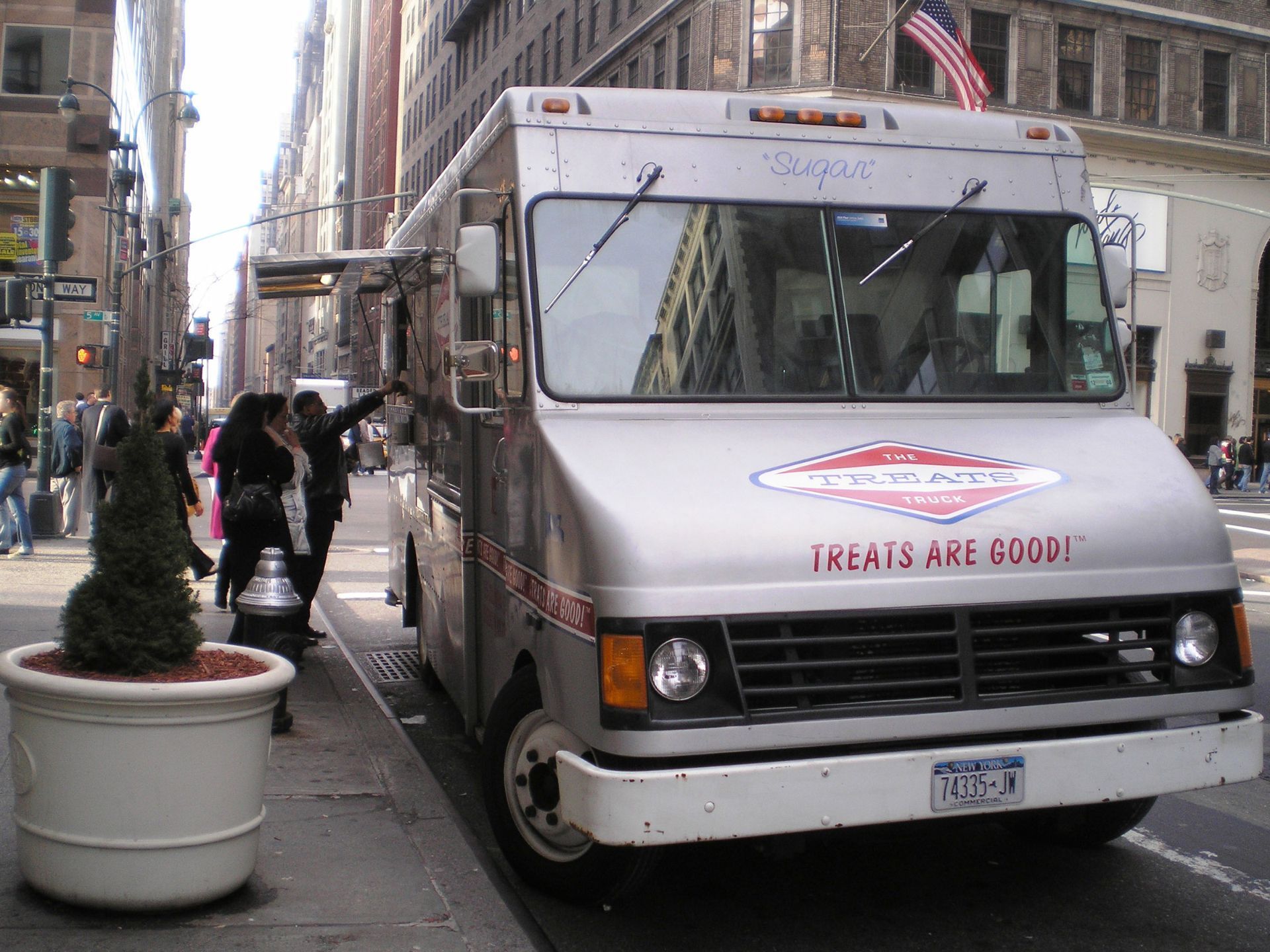 A food truck that says treats are good on the front