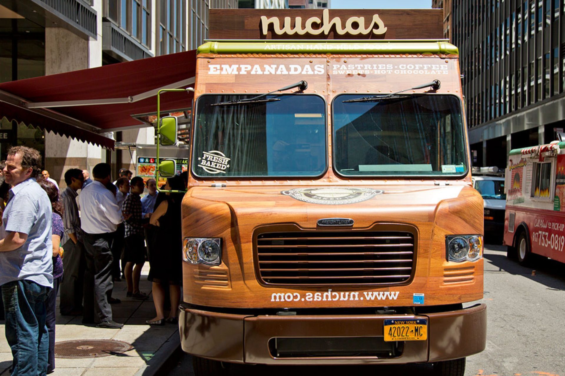 A nuchas food truck is parked on the side of the road