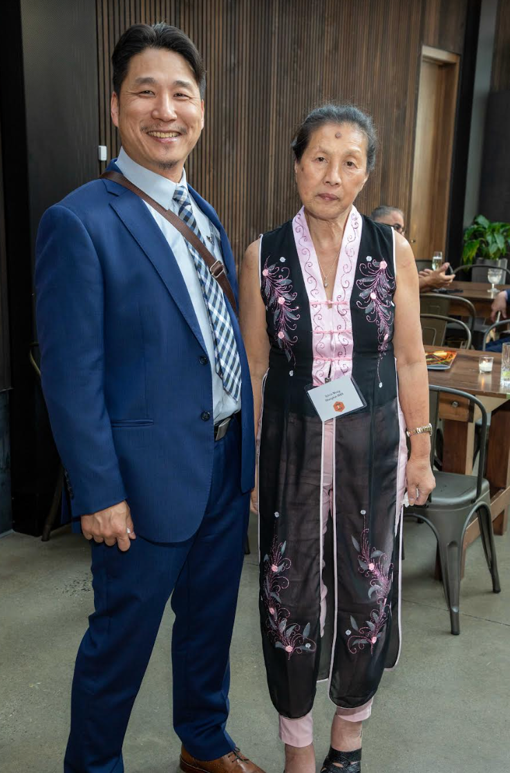 A man and a woman are standing next to each other in a room.