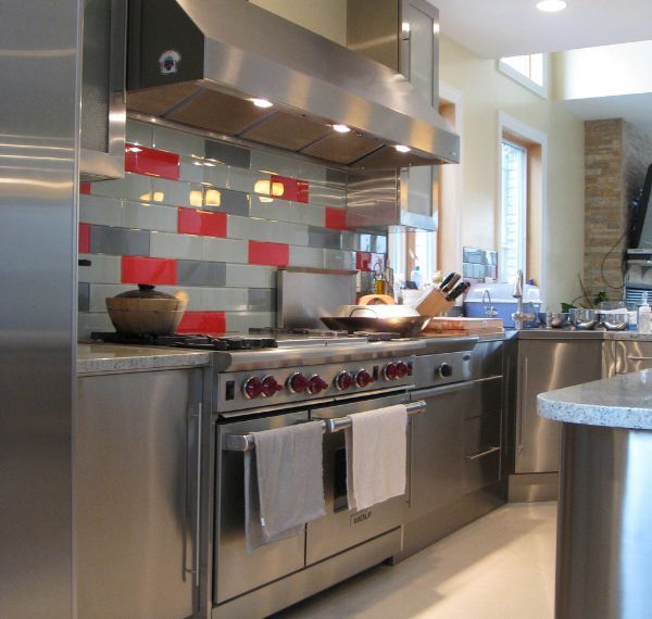 A kitchen with stainless steel appliances and a large island