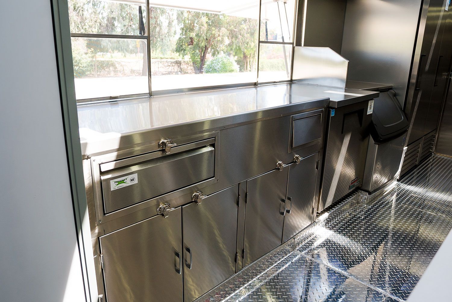 A kitchen with stainless steel cabinets and a window