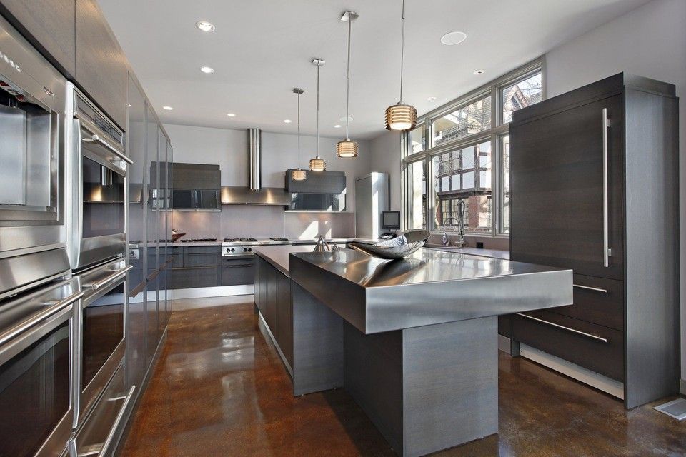 A kitchen with stainless steel appliances and a large island