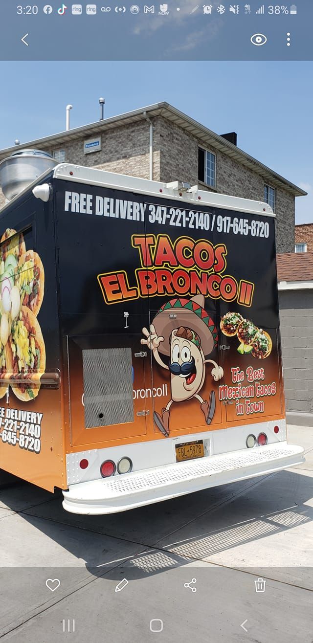 A taco truck is parked in front of a building.