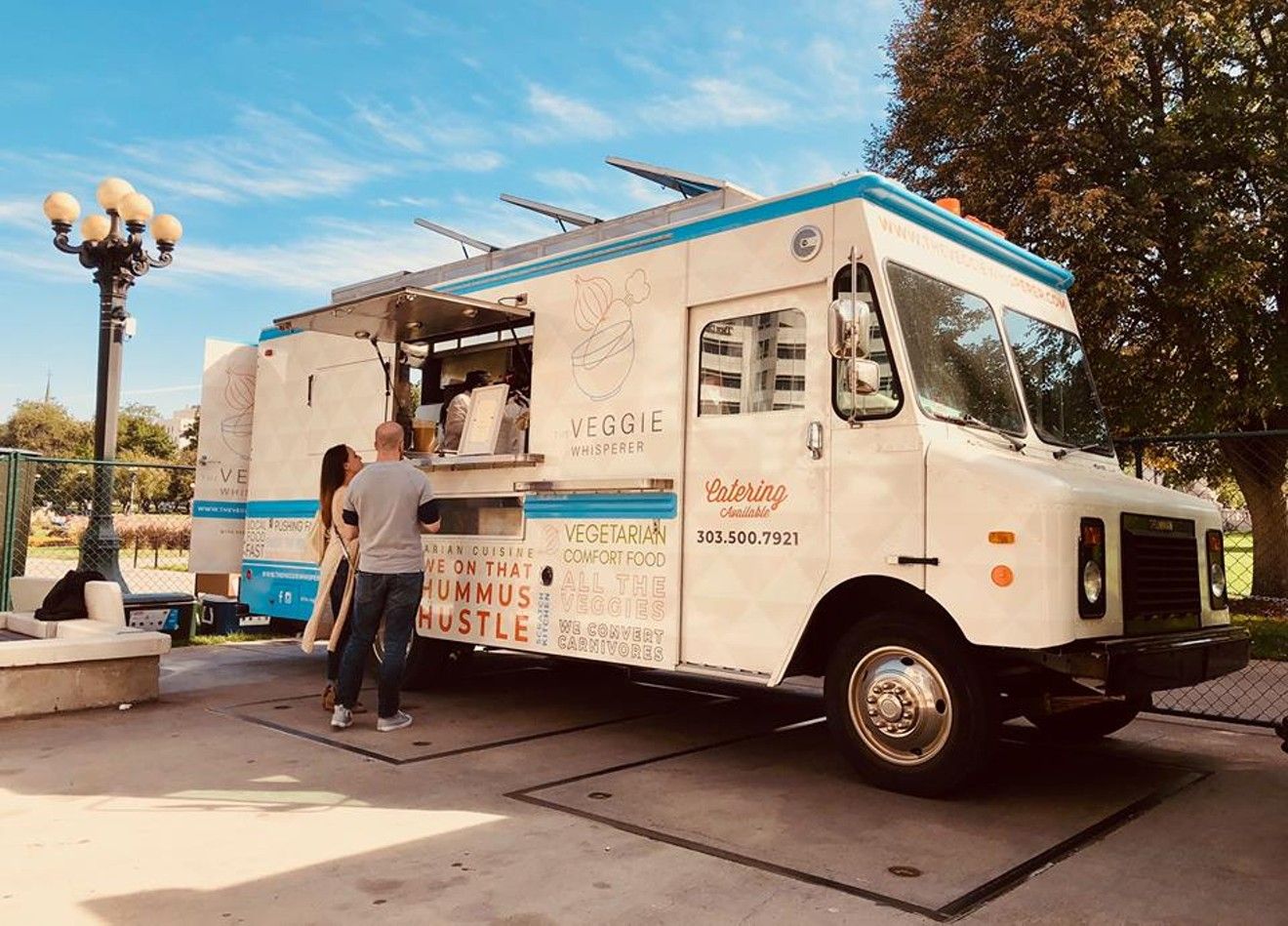 A man stands beside a food truck