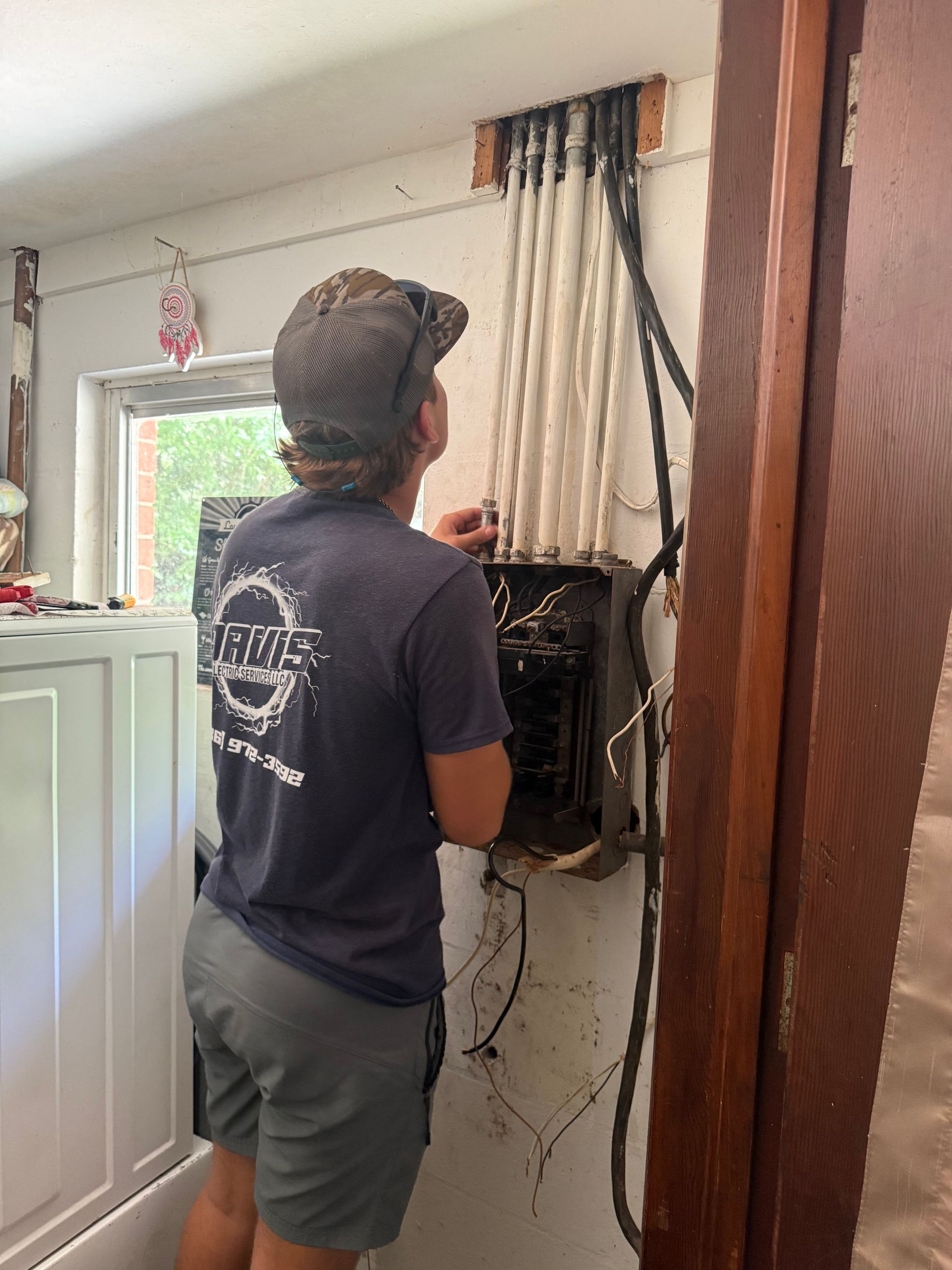 Person Working On An Electrical Panel With A Screwdriver - Palatka, FL - Davis Electric Services LLC