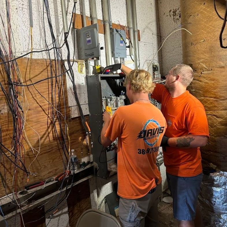 Two People Working On An Electrical Box - Palatka, FL - Davis Electric Services LLC Man Working On An Electrical Box - Palatka, FL - Davis Electric Services LLC
