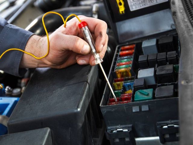 Mobile auto electrician testing a circuit in Coventry