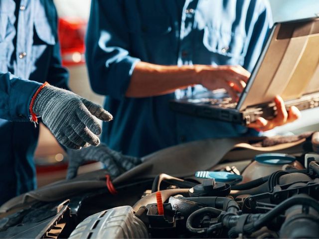 Auto electrician running diagnostics on a car in Coventry