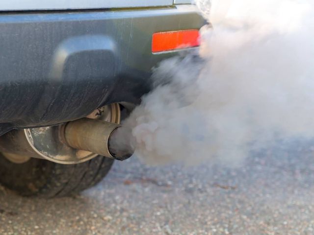 Smoking exhaust on a car waiting for repair in Nuneaton