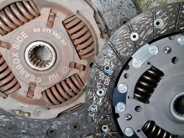 Old and new clutch plates from a Peugeot clutch replacement by D&E Auto Repairs to You