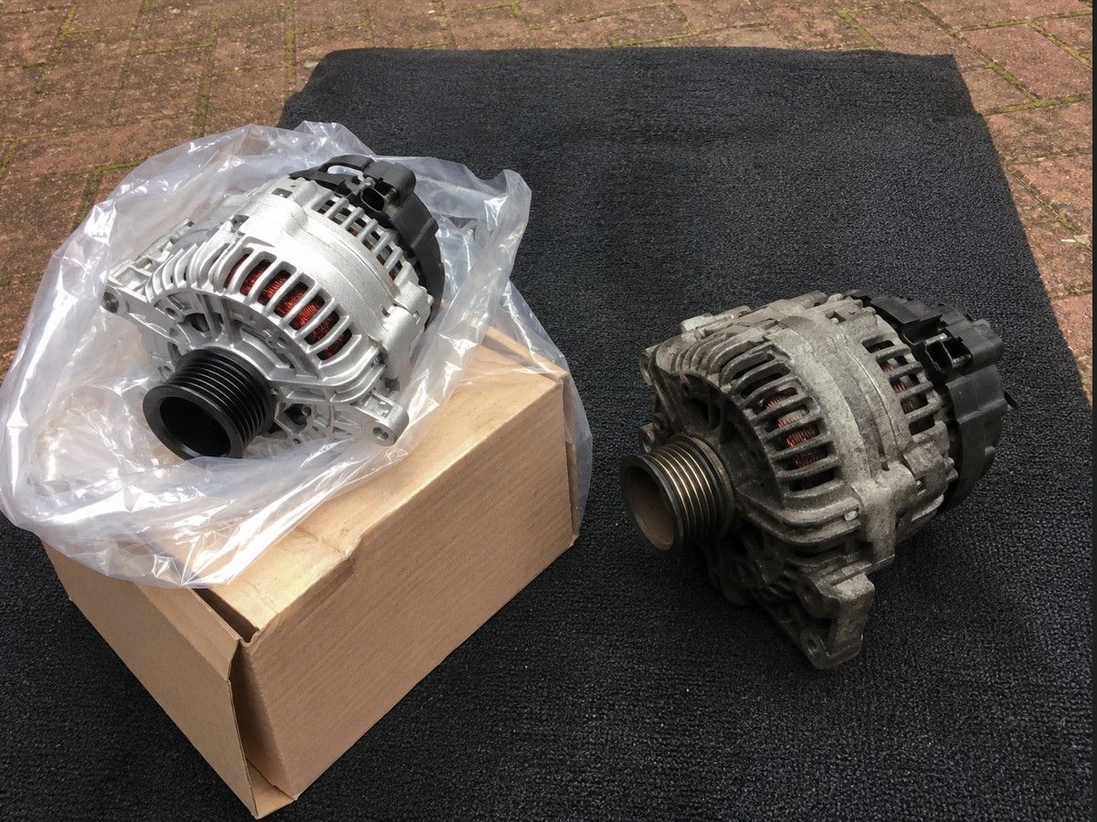 Old alternator removed from a car engine during a mobile mechanic visit in Coventry