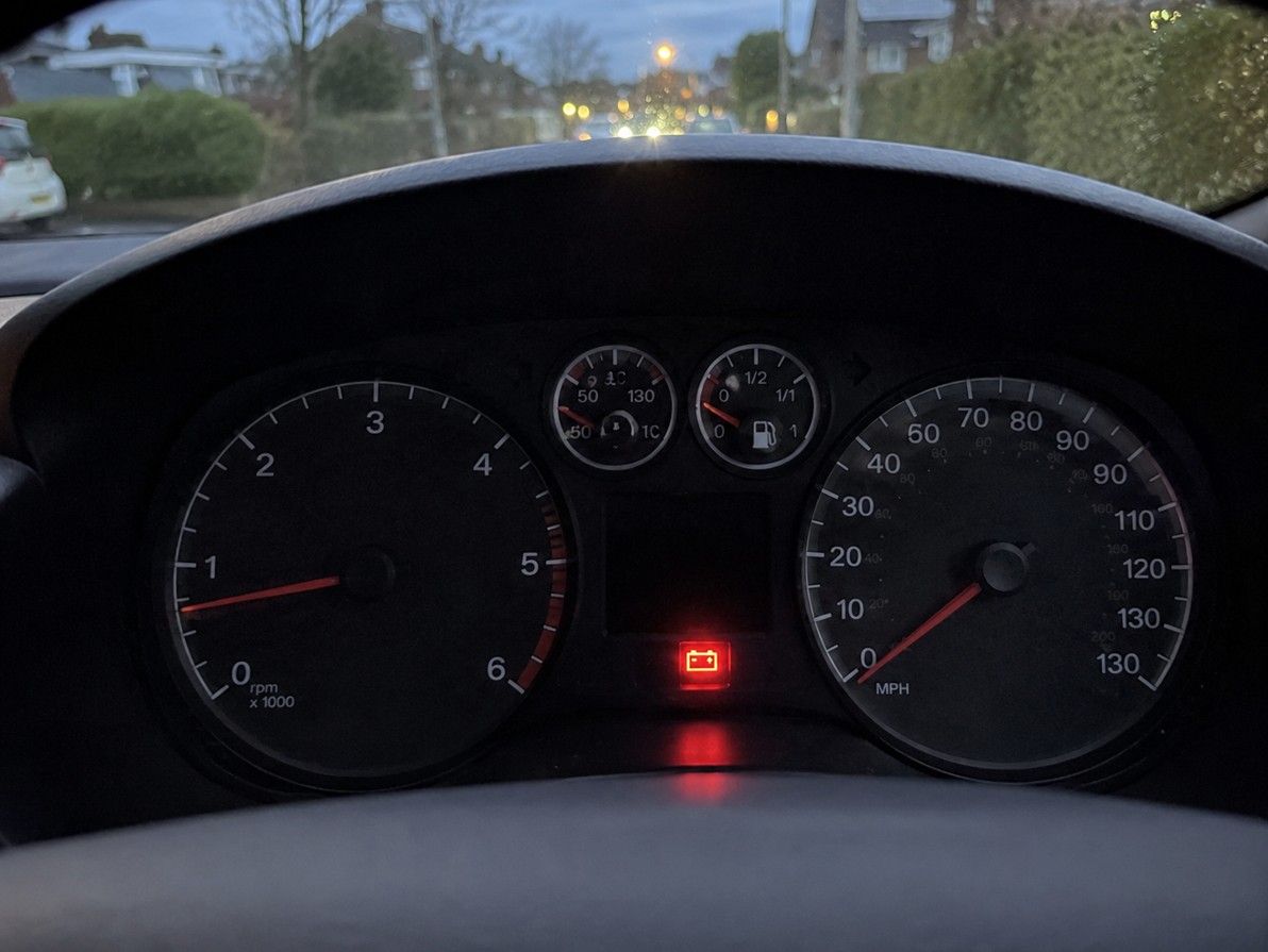 Car dashboard showing battery warning light — often caused by a failing alternator rather than the battery itself