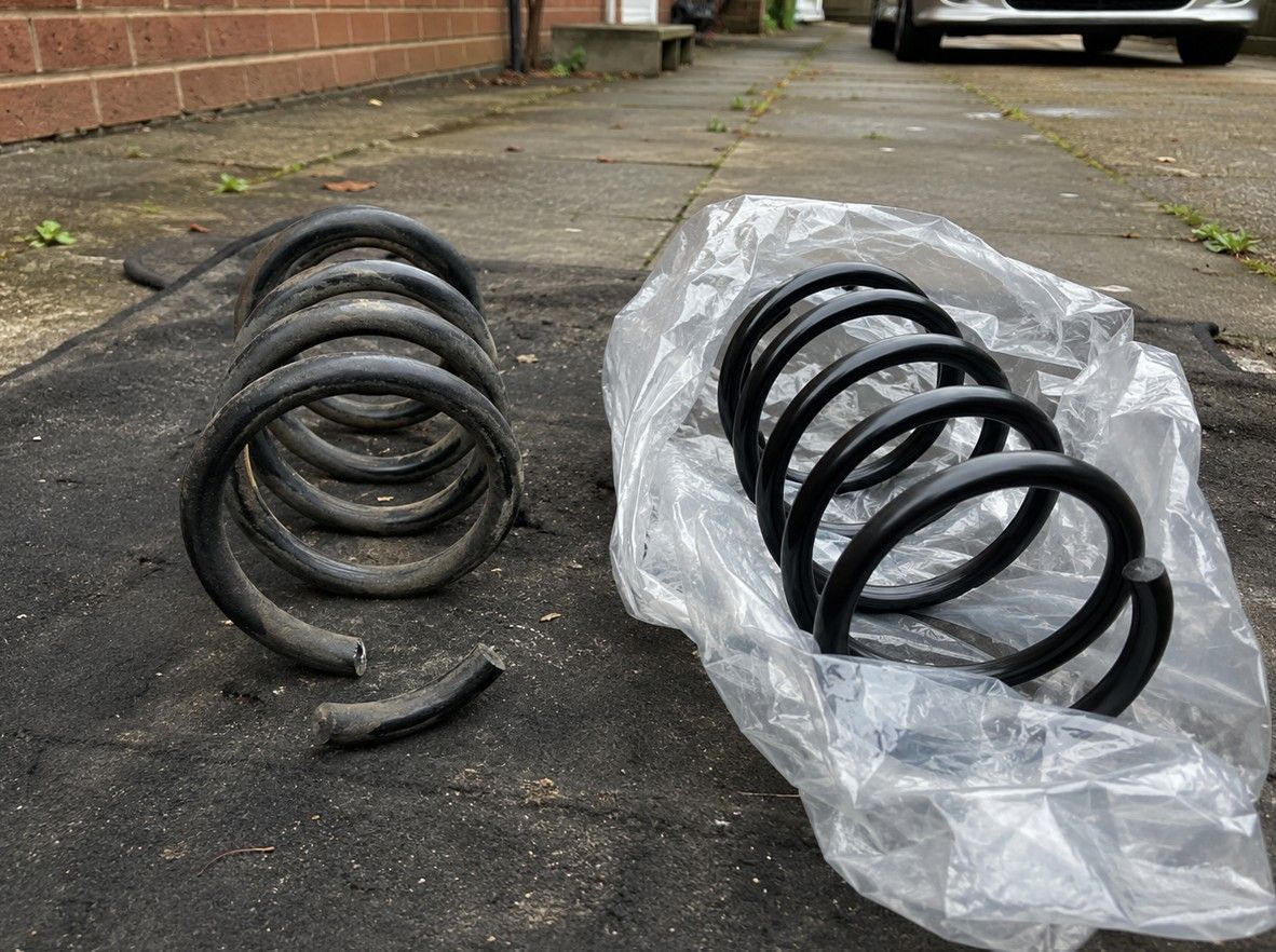 Worn coil spring removed from a car during a mobile suspension repair in Coventry
