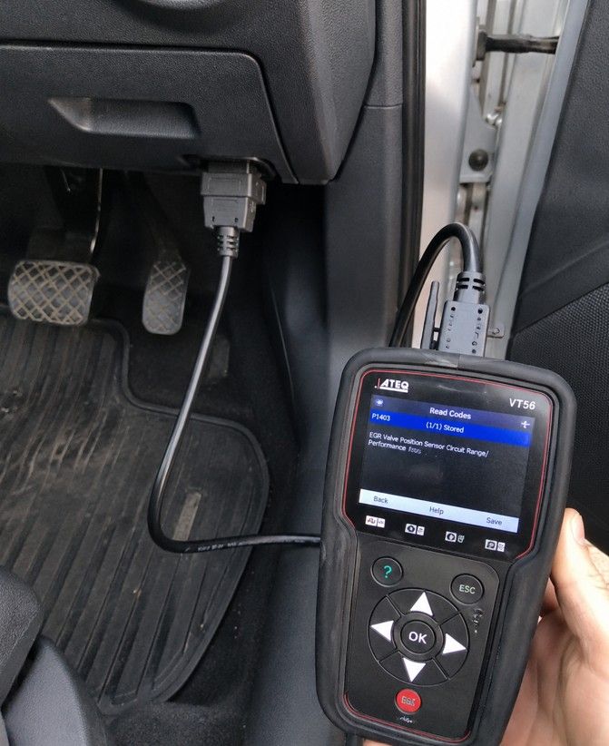 Mobile mechanic connecting OBD diagnostic equipment to a car during an emergency callout in Coventry