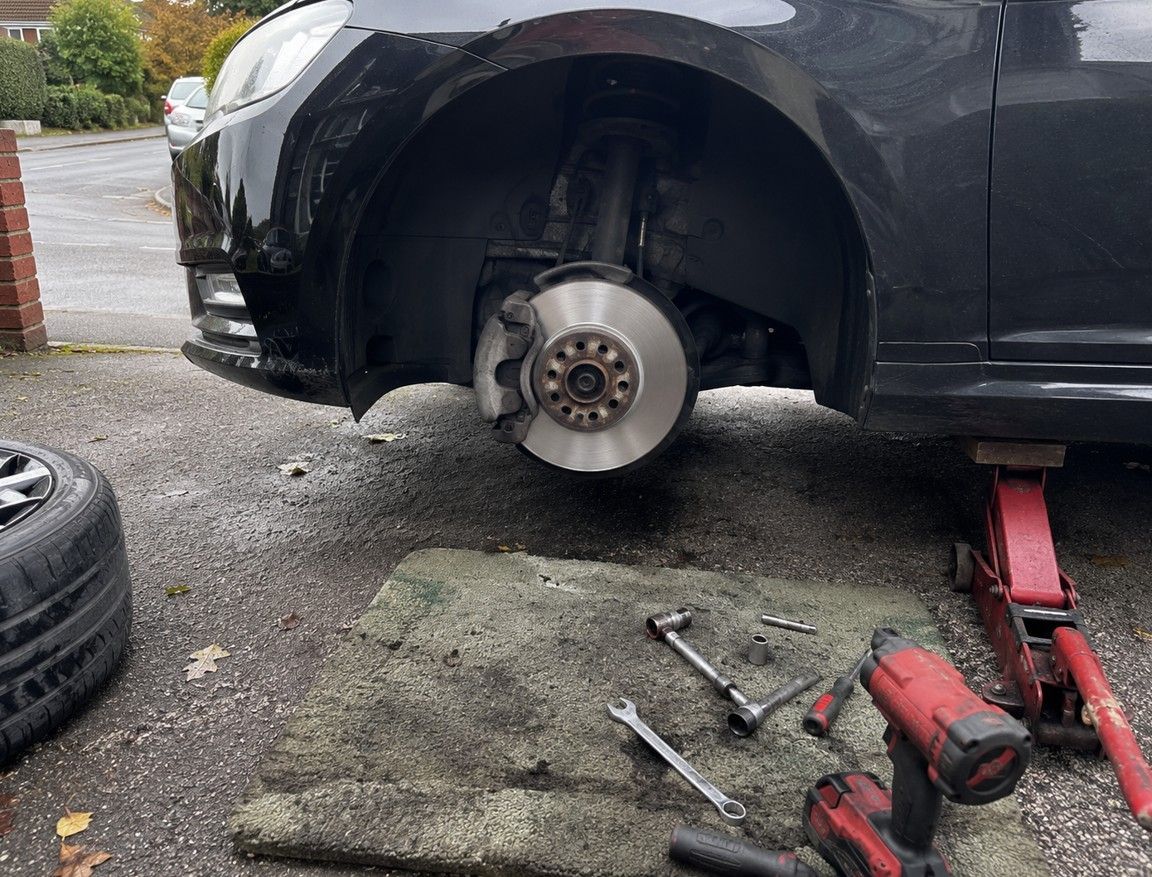 Mobile mechanic carrying out an emergency roadside brake repair on a vehicle in Coventry