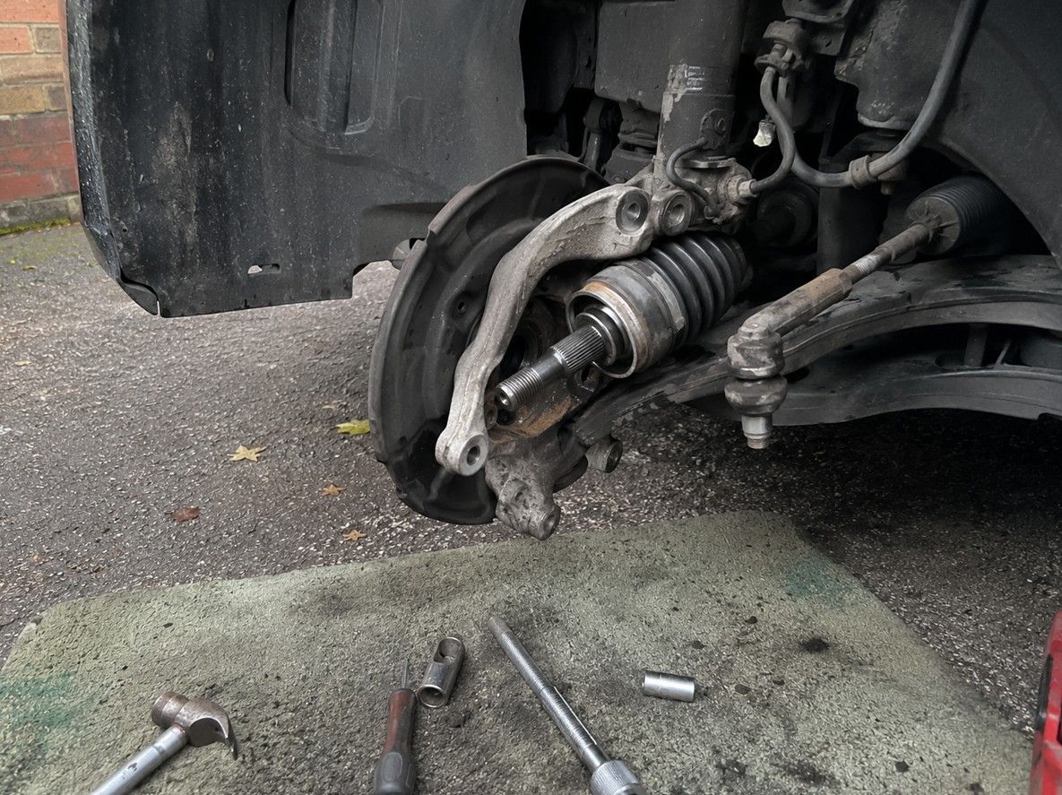 Wheel bearing and driveshaft replacement in progress during a mobile mechanic visit in Coventry
