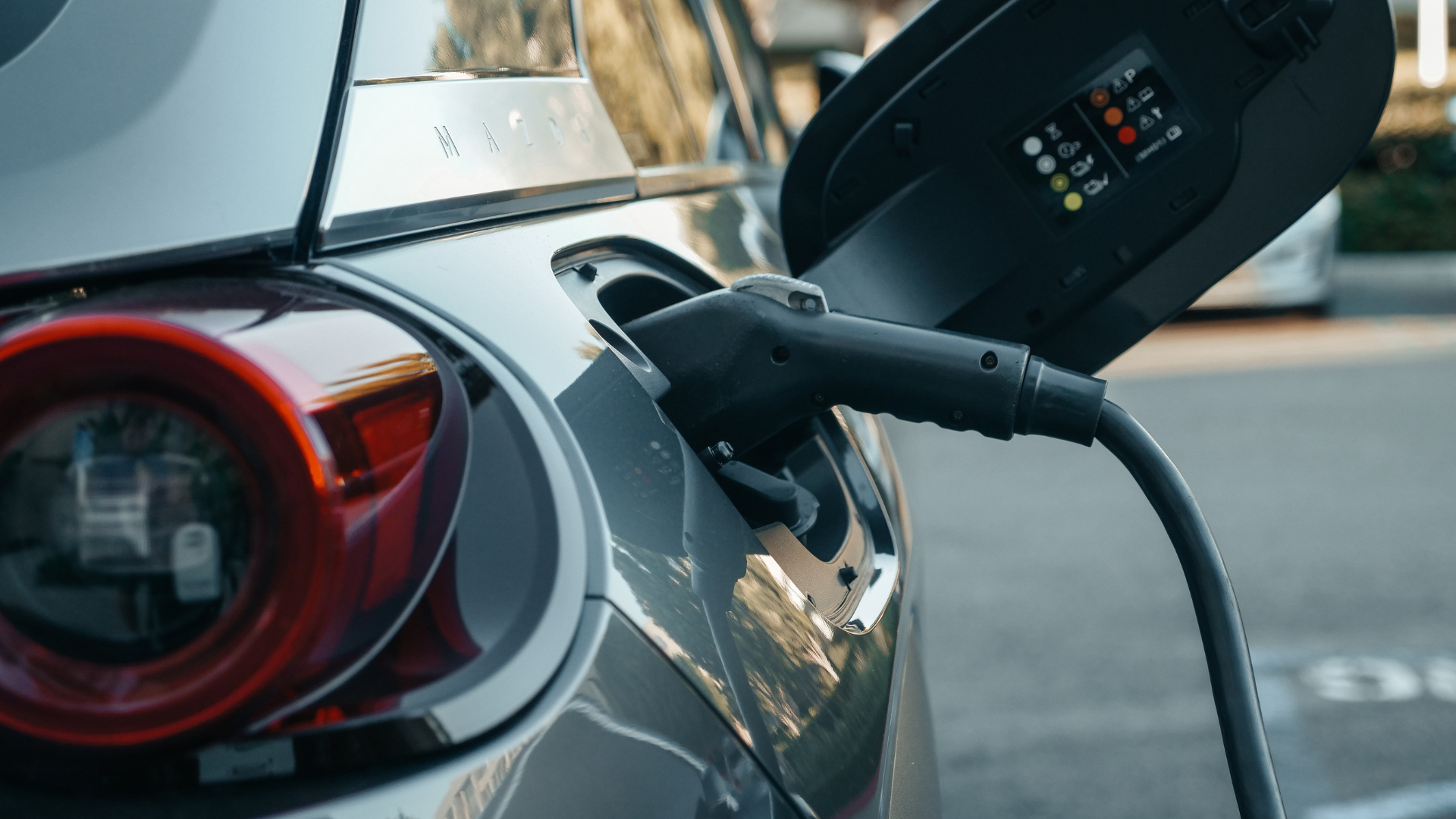 An electric car is being charged at a charging station.