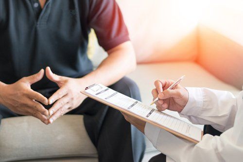 Man Consulting for a Health Insurance — Miami, FL — American Quality Assurance Group