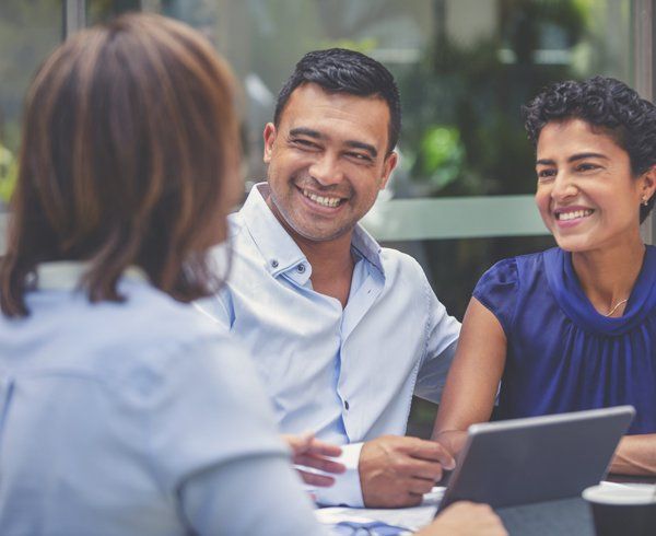 Insurance Agent Talking to Clients — Miami, FL — American Quality Assurance Group Insurance Agent Talking to Clients — Miami, FL — American Quality Assurance Group