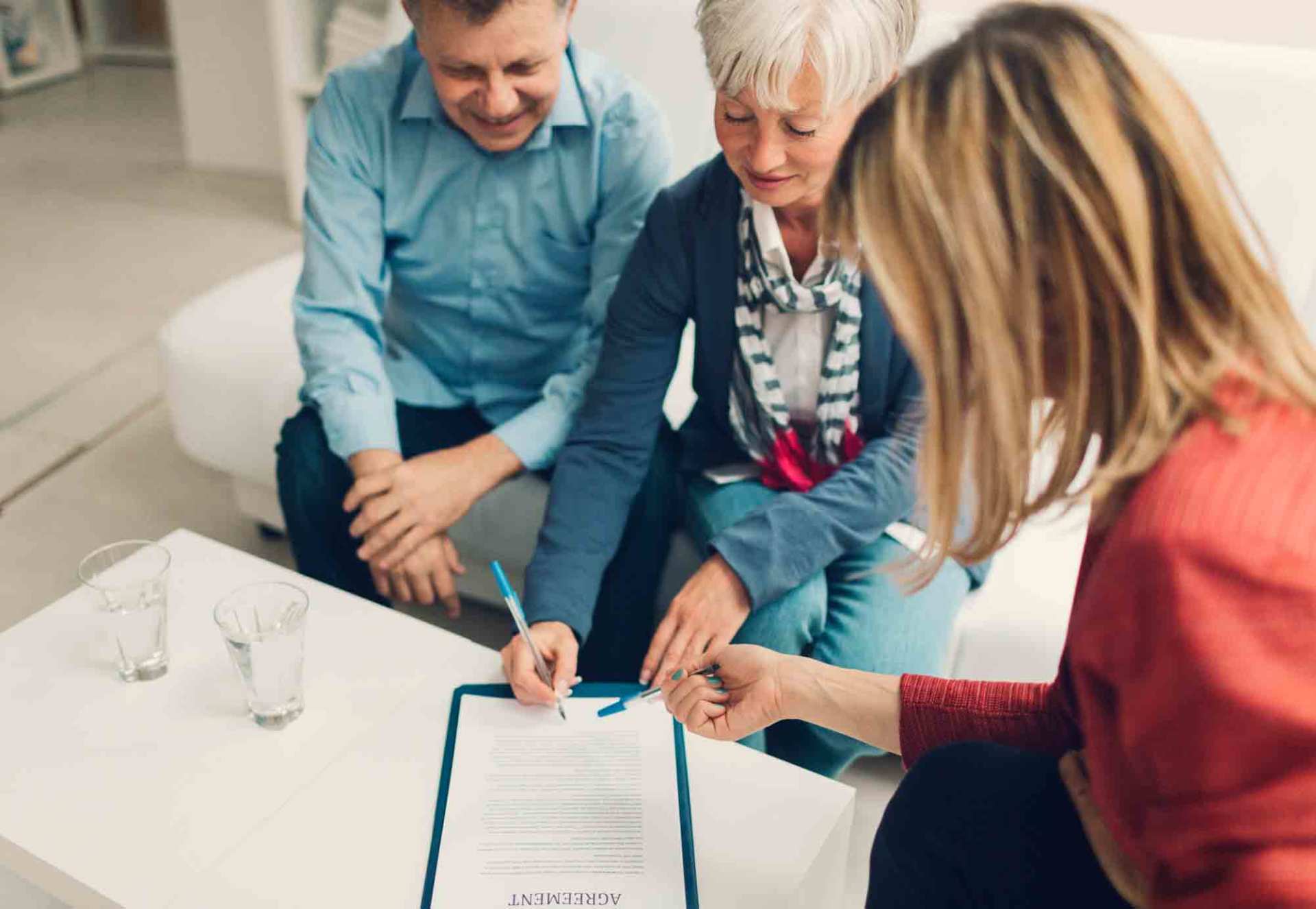 Elder Couple Signing Life Insurance — Miami, FL — American Quality Assurance Group Elder Couple Signing Life Insurance — Miami, FL — American Quality Assurance Group