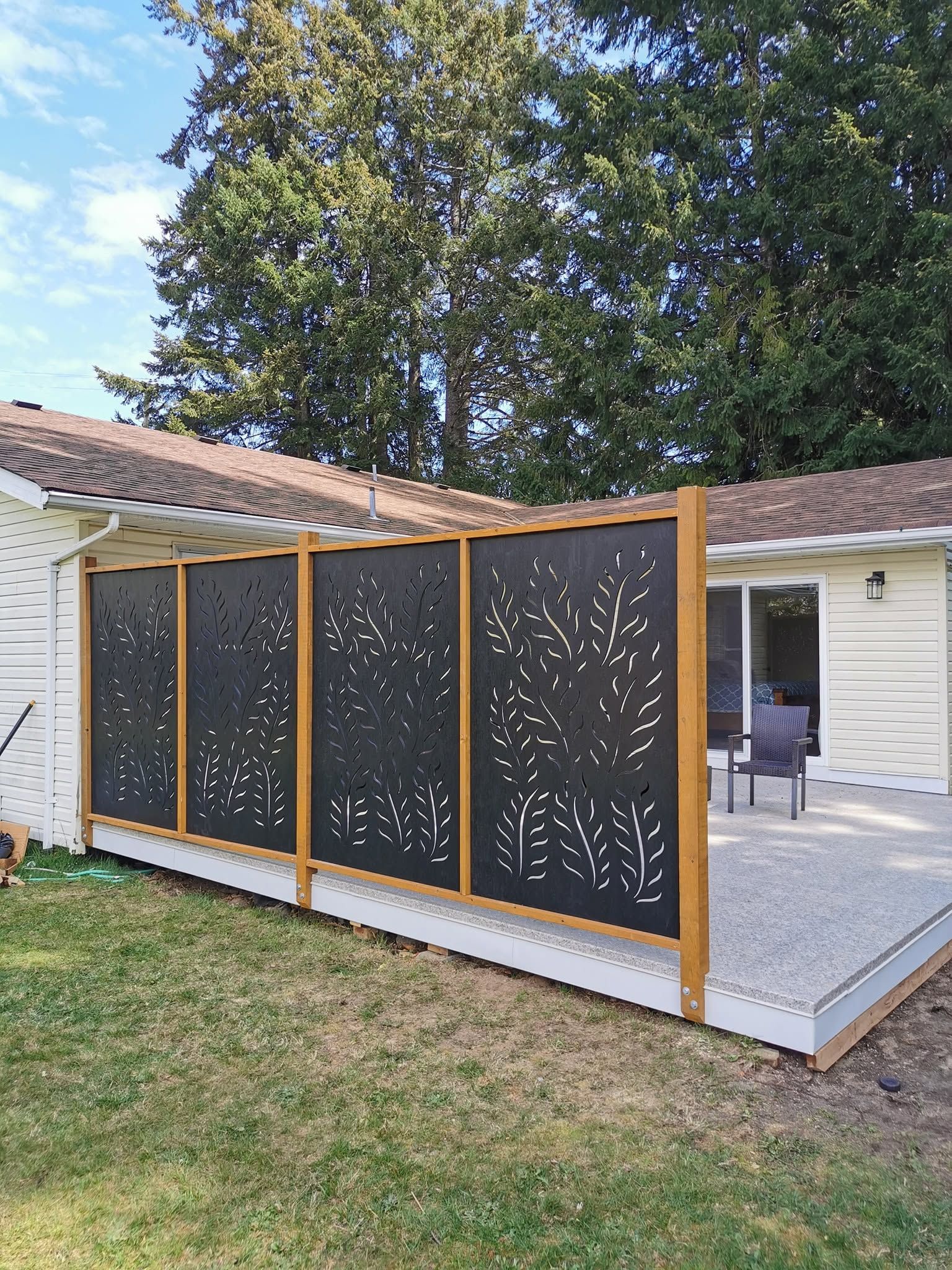 A white house with a black fence in front of it.