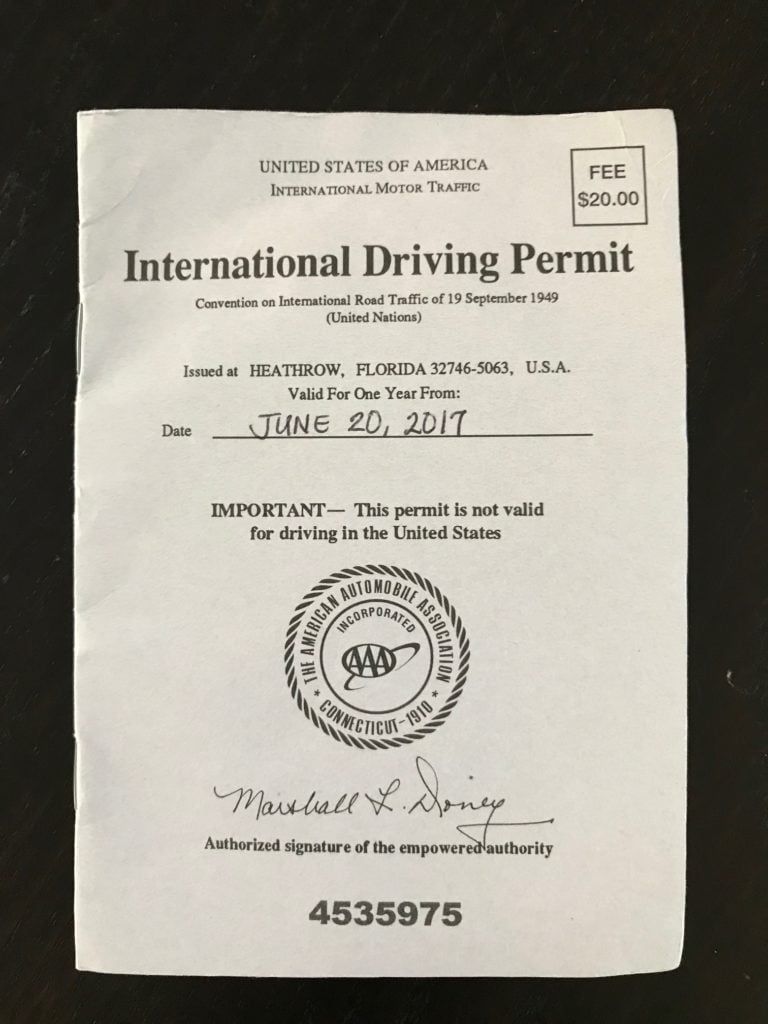 International Driving Permit document with black text on a light background, centered seal and signature line