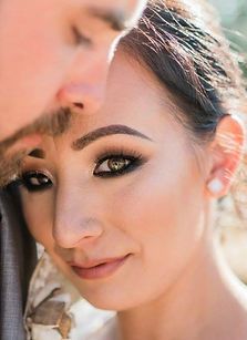A close up of a woman 's face next to a man 's face.