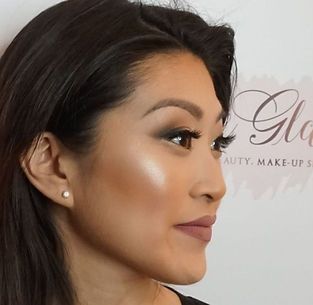A close up of a woman 's face in front of a sign that says beauty make up