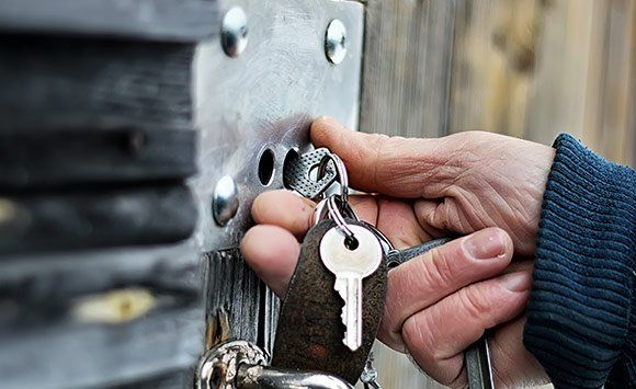 Putting Keys On Wooden Gate — Ottumwa, IA — Mobile Locksmith Putting Keys On Wooden Gate — Ottumwa, IA — Mobile Locksmith