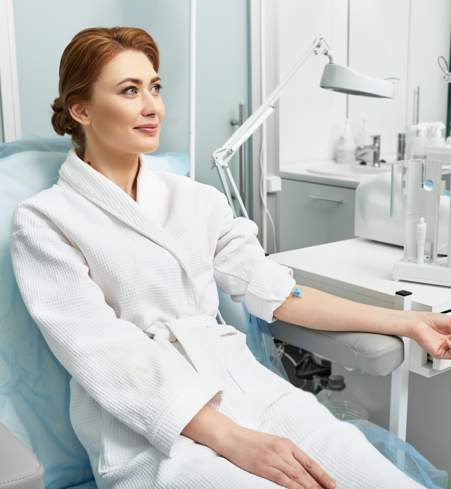 PRF | Top Biological Dentist in Morgantown WV A woman in a bathrobe is sitting in a chair with her arm on a table.