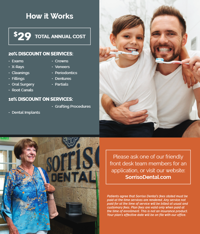A man is holding a child who is brushing his teeth.