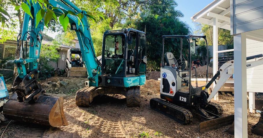 Two Excavators, a Teal One and A Black/white One — Lifestyle Demolition In Tweed Heads, NSW