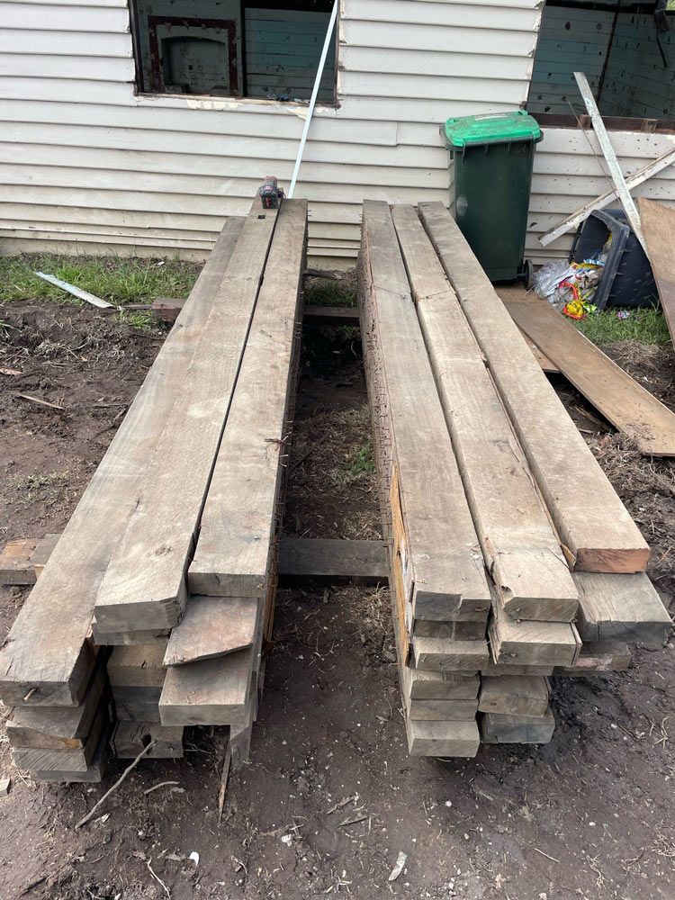 A Bulldozer Is Loading Dirt Into a Truck — Lifestyle Demolition In Brunswick Heads, NSW