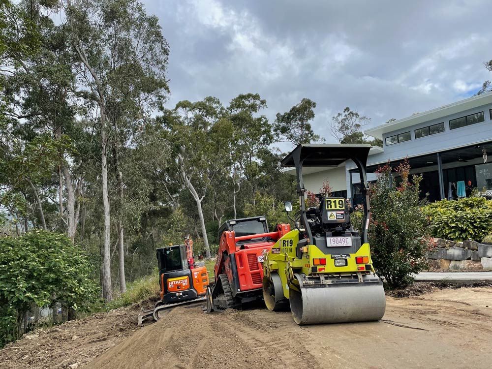 A Yellow Excavator Is Digging a Hole in The Ground — Lifestyle Demolition In Murwillumbah, NSW