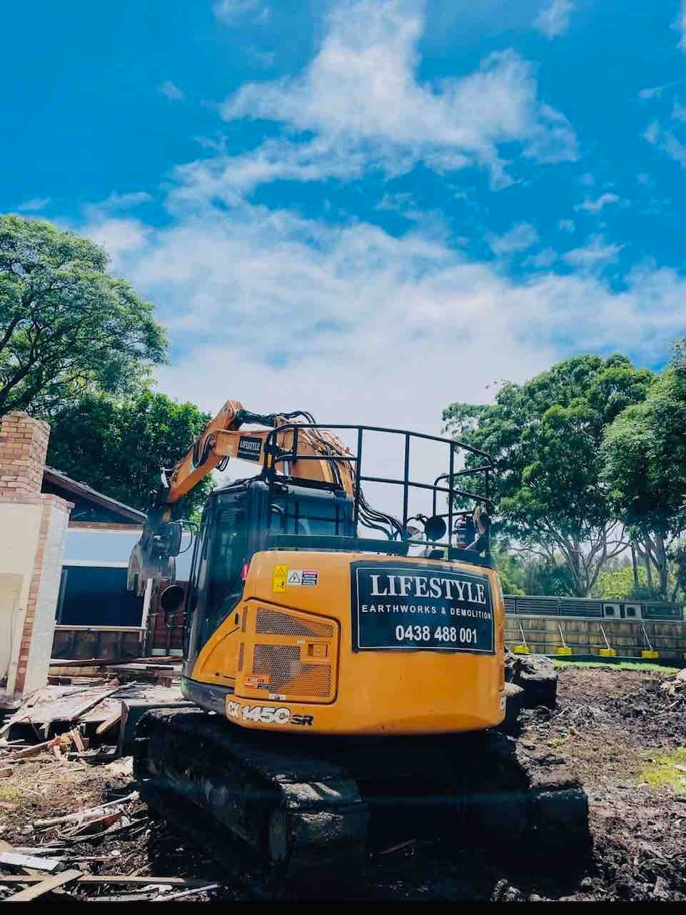 A Large Building Is Being Demolished by A Crane — Lifestyle Demolition in Kingscliff, NSW