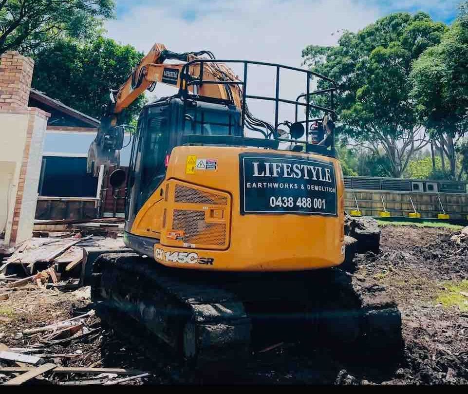 A Large Building Is Being Demolished by A Bulldozer — Lifestyle Demolition In Murwillumbah, NSW