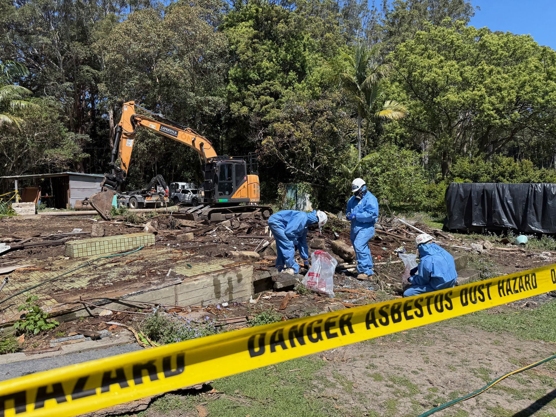 Construction Workers in Blue Protective Suits at A Contaminated Site — Lifestyle Demolition In Murwillumbah, NSW