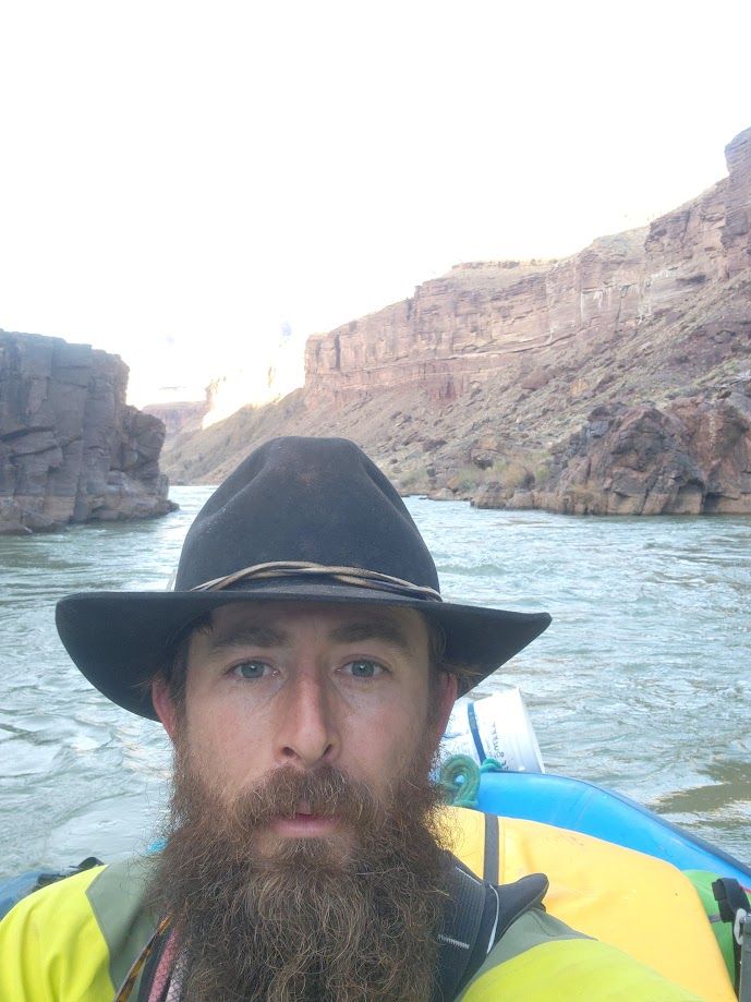 A man with a beard wearing a cowboy hat