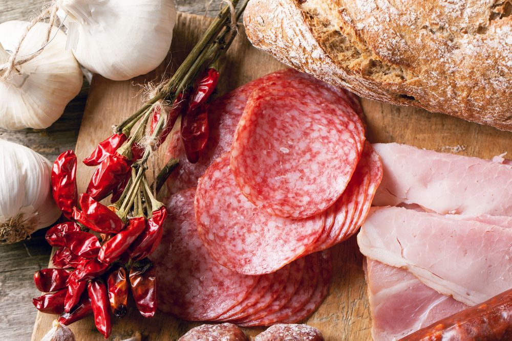 A Wooden Cutting Board Topped With Products — Corrado & Frank Distributors in Bowral, NSW
